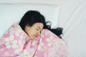 woman-sleeping-on-bed-2024-09-16-10-11-27-utc - Synergy Dental