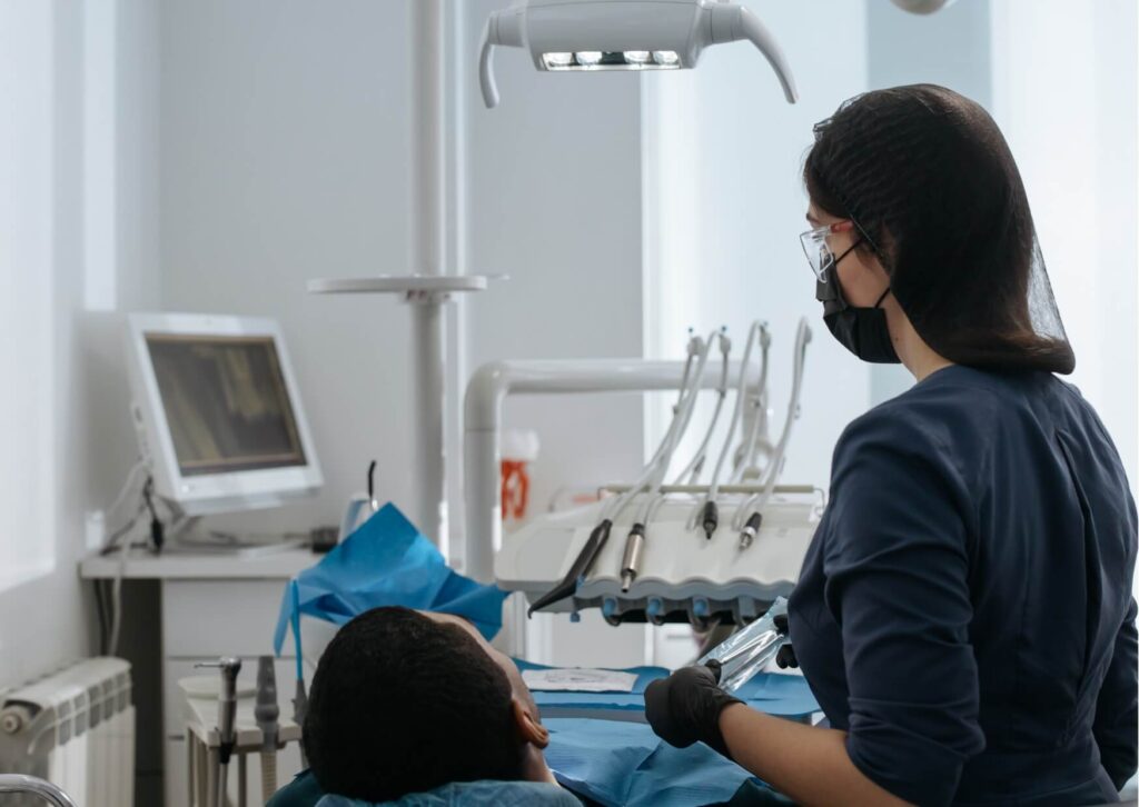 Dentist examining a patient for cavities to determine whether tooth decay can be treated before it worsens.
