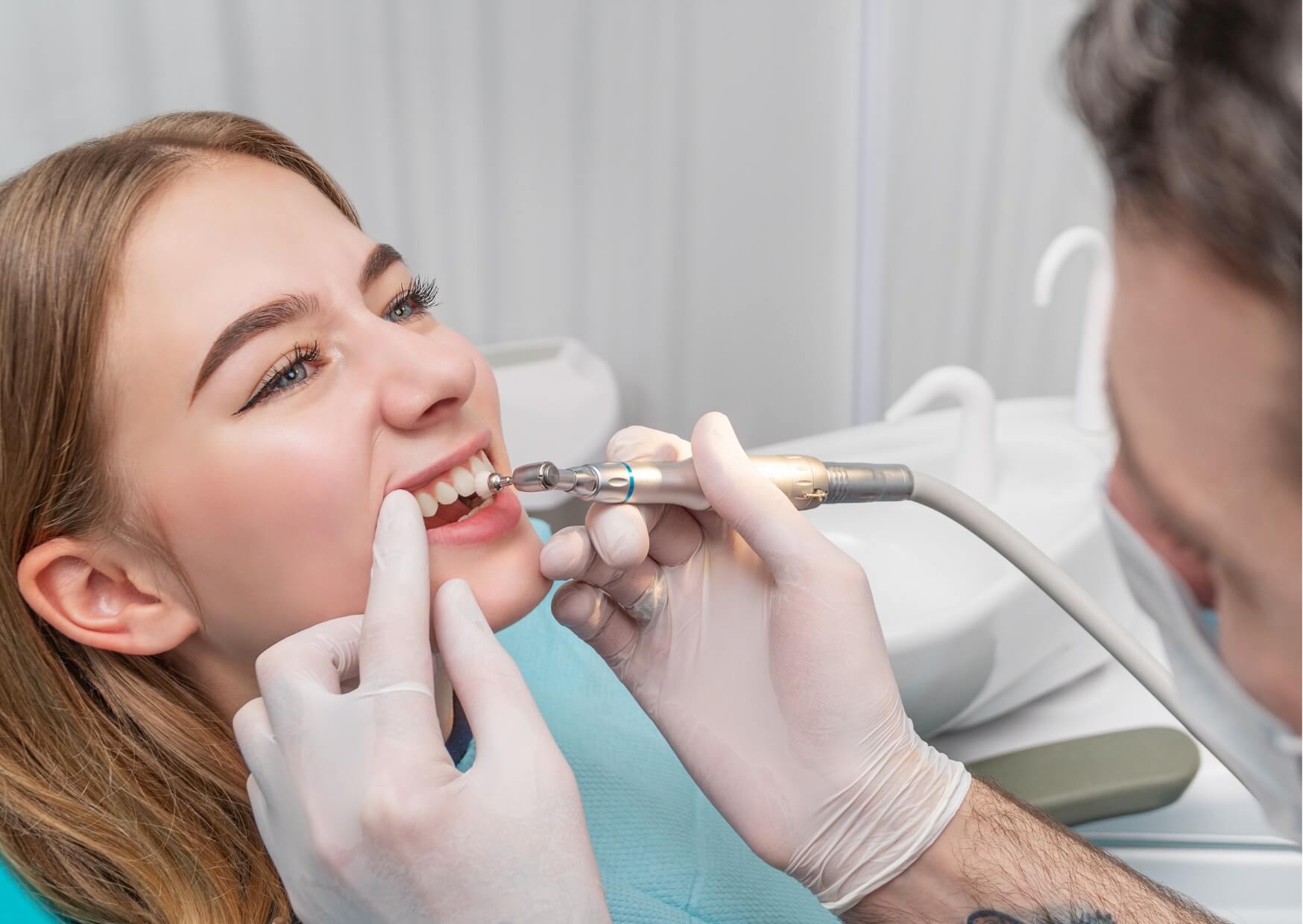 Dentist placing a tooth-colored composite filling to restore a cavity while preserving the natural appearance of the tooth